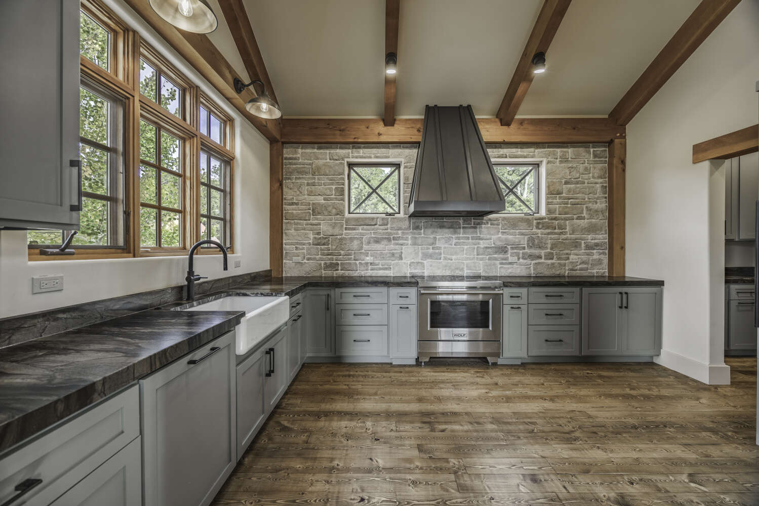 Custom timber-frame kitchen with sage green cabinets