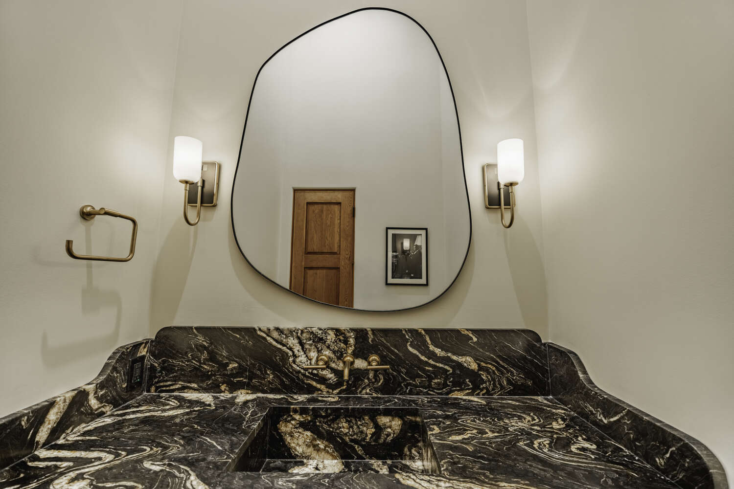 Luxury powder room with black and gold marble vanity