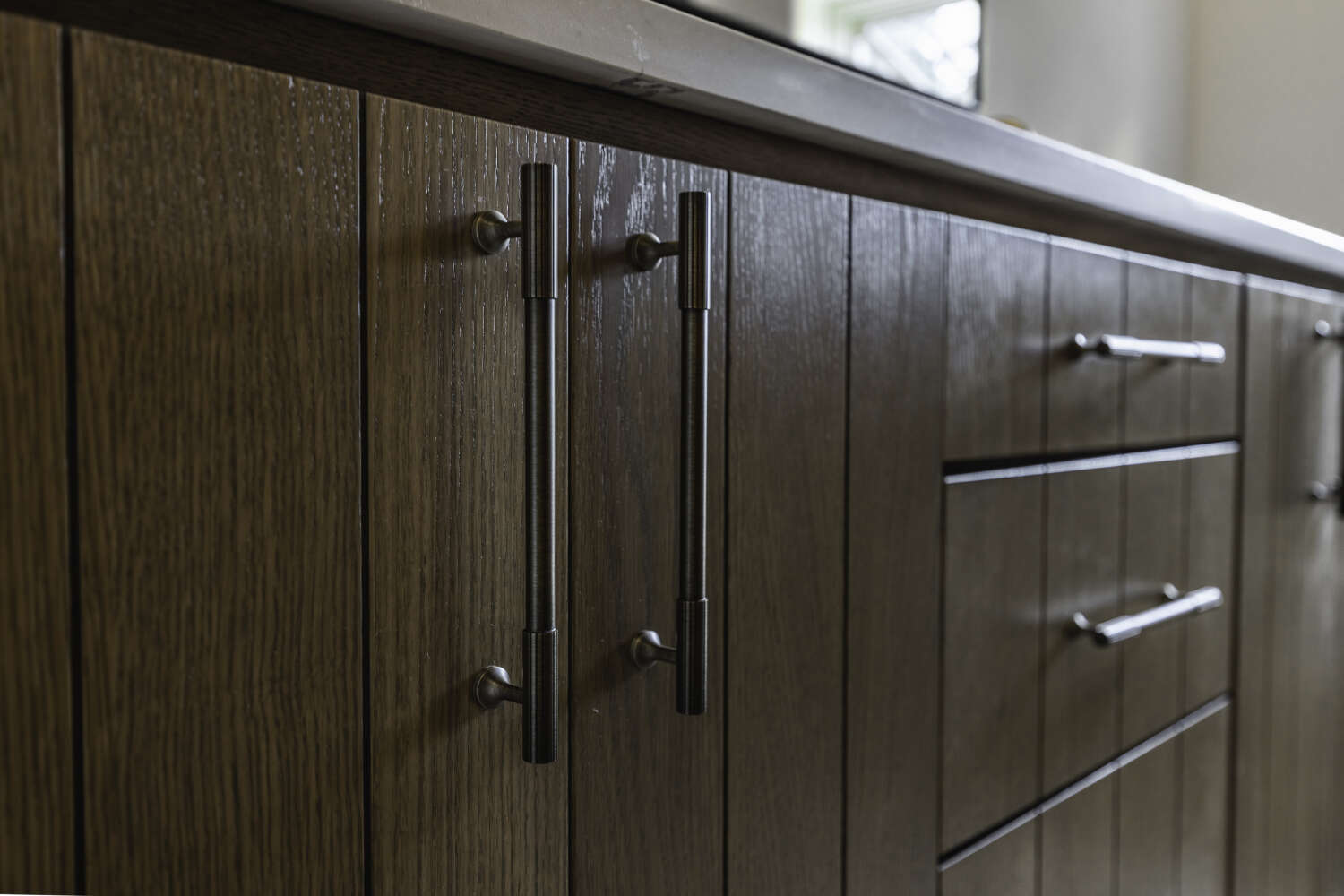 Cabinet hardware detail — brass bar pulls